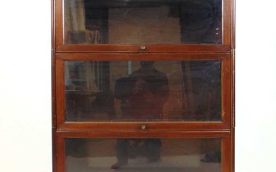 An early 20th century walnut sectional bookcase, comprising of plinth,...