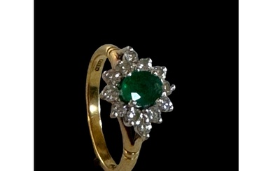 An emerald and diamond cluster ring Mounted in 18ct gold, m...