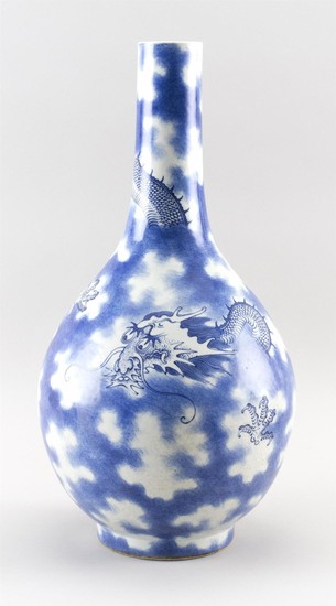 CHINESE BLUE AND WHITE PORCELAIN BOTTLE VASE Decoration of a five-clawed dragon in clouds. As-is condition. Height 20". Provenance:...
