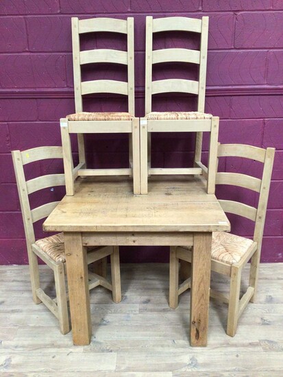 Contemporary light oak dining table and four matching ladder back chairs with rush seats
