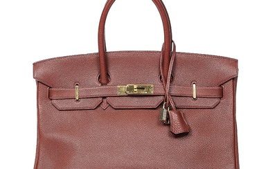 Hermès A “Birkin 35” bag of burgundy Togo leather with gold tone...