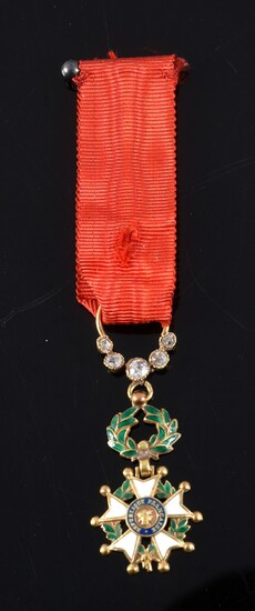 ORDER OF THE LEGION OF HONOUR (France). Miniature knight badge, gold and enamel, set with diamond roses, with red moiré silk taffeta ribbon, kept in its original case. Damage to the ribbon, but good condition. H. : 4 cm - L. : 1,5 cm.Gross weight :...