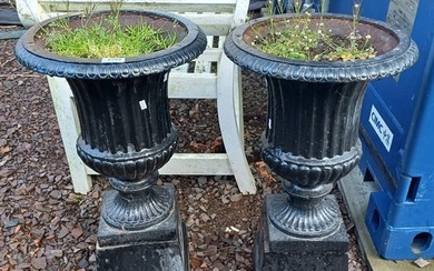 PAIR OF PAINTED CAST IRON GARDEN URNS ON SQUARE PLINTHS, HEI...