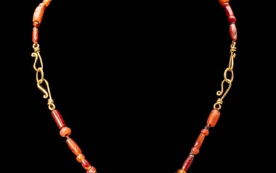 PTOLEMAIC PERIOD CARNELIAN AND GOLD NECKLACE WITH SUN PENDANT