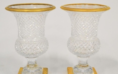 Paire de vases en cristal taillé en pointe de diamant et cerclé de bronze doré....
