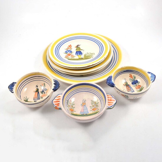 Quantity of Quimper faience earthenware plates and bowls.