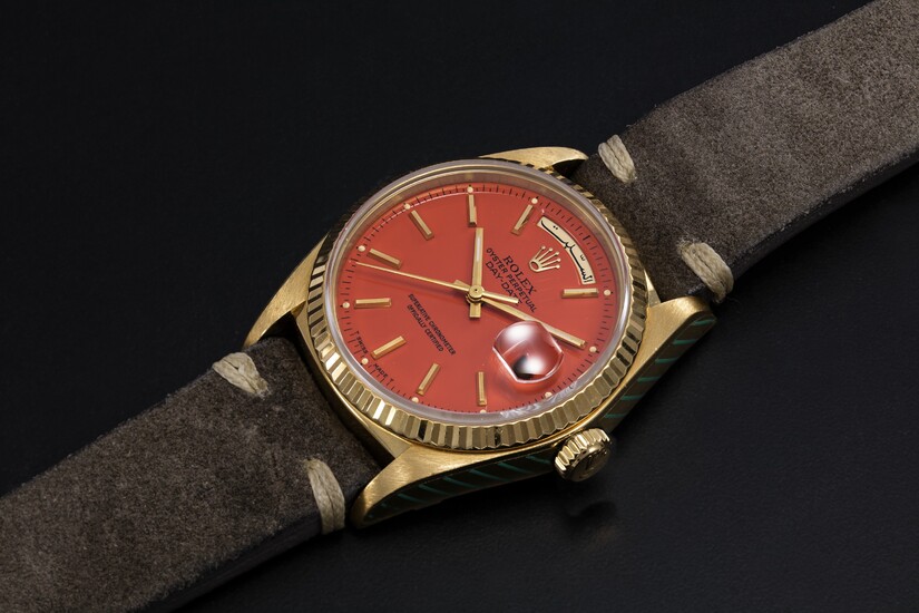 ROLEX, A GOLD OYSTER PERPETUAL DAY-DATE WITH ORANGE STELLA DIAL AND ARABIC CALENDAR, REF. 18038