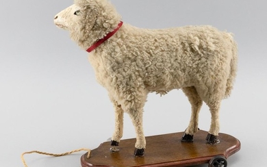 SHEEP PULL TOY Composition sheep on a wooden base. Length 14".
