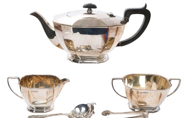 Silver three piece tea set with a tea strainer and sugar tongs