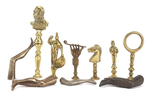 Ten antique pipe tampers including King George V, horse head...