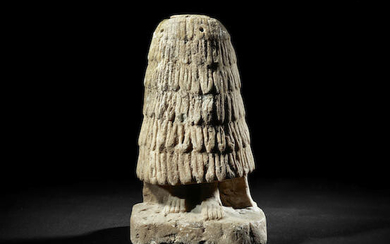 The lower portion of a large Sumerian limestone worshipper figure