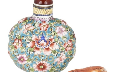Two Chinese snuff bottles, 19th century, one a painted Canton enamel snuff bottle decorated with flowering lotus and chrysanthemum blossoms amongst leafy stems, the other a coral snuff bottle carved as a hanging fruit, 54.cm-6.5cm long (2)