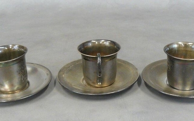 Three cups and saucers in solid silver (Minerva) with guilloche...