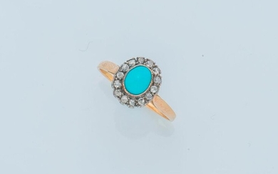 18 karat (750 thousandths) yellow gold ring set with a turquoise cabochon in a ring of rose-cut diamonds.