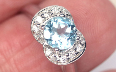 28$---6 MM. Sky Blue Topaz & White Cubic Zirconia Ring...