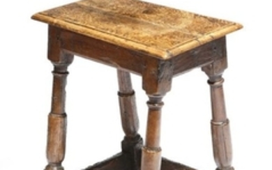 A 17th century oak joint stool, the later seat on …