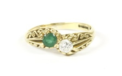 An 18ct gold emerald and diamond crossover ring