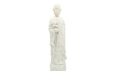 A CHINESE BLANC-DE-CHINE MODEL OF GUANYIN HOLDING A...