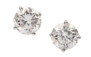 A pair of diamond earstuds Each brilliant-cut diamond,...