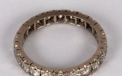 A diamond eternity ring set in white precious metal