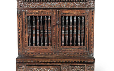 A rare Charles I joined and boarded oak, fruitwood and parquetry inlaid mural livery cupboard, West Country, circa 1640