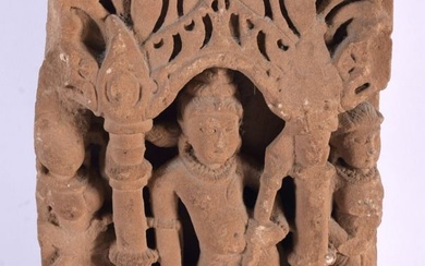 A 10th / 11th Century Buff Sandstone Relief depicting Shiva in Tribhanga in an alcove flanked by pil