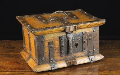 A 17th Century Spanish Wooden Iron Bound Box. The rectangular lid chip carved with a decorative roun