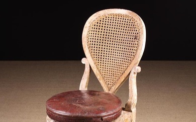 A 19th Century Harpist's Chair in the Louis XVI Style. The round, height-adjustable revolving cushio