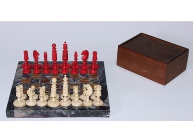 A 19th century bone Barleycorn pattern chess set, red staine...