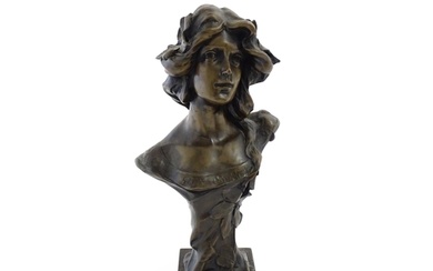 A 20thC cast bust depicting an young lady in the Art Nouveau...