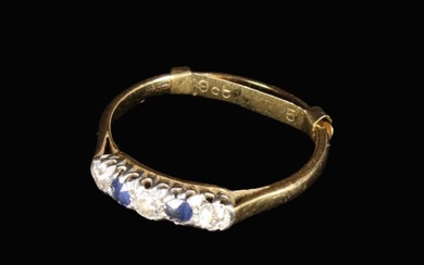 A 9 Carat Gold Lady's Ring set with three diamonds flanking two sapphires, housed in an old W.H. Tho