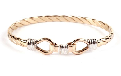A 9ct yellow and white gold ropetwist bangle