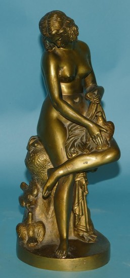 A Bronze Figure of a seated female nude holding a bird, 29cm...