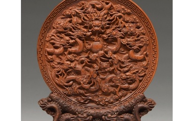 A Chinese sandalwood roundel, 19th c, finely carved with dra...