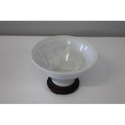 A Chinese white porcelain bowl with "ghost decoration" of tw...