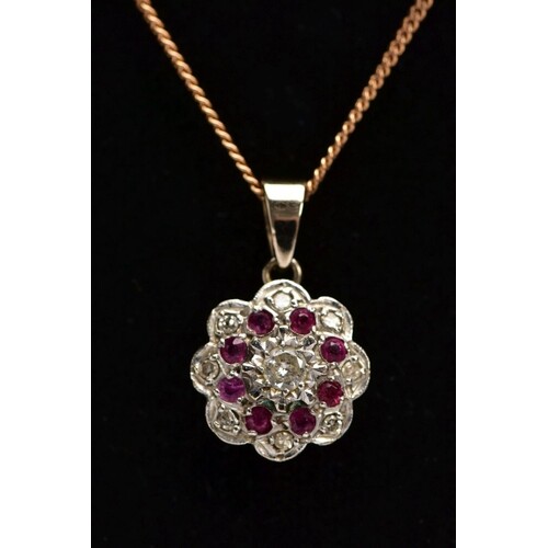 A DIAMOND AND RUBY PENDANT NECKLACE, the yellow metal pendan...