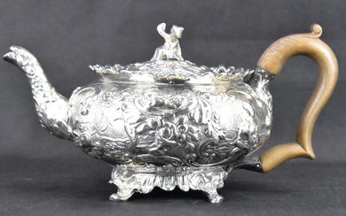 A George III hallmarked silver teapot with all-over Oriental and...