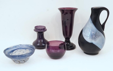 A Julia Donnelly studio glass bowl, with blue marbleised design, signed and dated 1986, 16.5cm diameter; together with: a studio glass jug, unsigned, 28cm high; and three purple glass vases/bowl (5) ARR