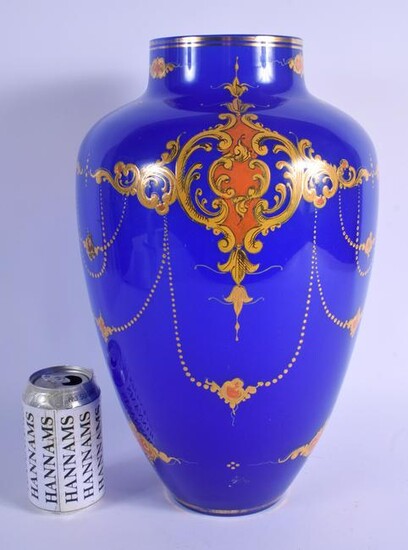 A LARGE TURKISH OTTOMAN BLUE GLASS VASE enamelled with