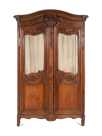 A Louis XV Provincial Style Carved Walnut Armoire