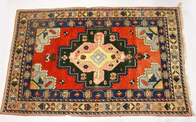A PERSIAN RUG, 20TH CENTURY, bright red ground with