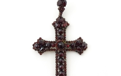 A Victorian pendant of crucifix form set with garnets. Appro...