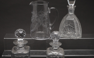 A WEBB CORBETT CUT CRYSTAL DECANTER, A SQUARE CUT GLASS DECANTER, AND AN ENGRAVED GLASS PITCHER.