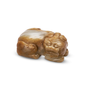 A WHITE AND RUSSET JADE CARVING OF TIANLU, QING DYNASTY, 17TH CENTURY