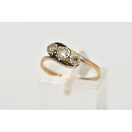 A YELLOW METAL, THREE STONE DIAMOND RING, of a crossover des...