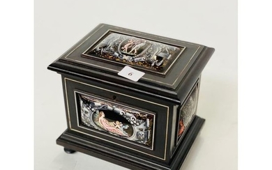 A blackened wooden box inlaid with bone filets...