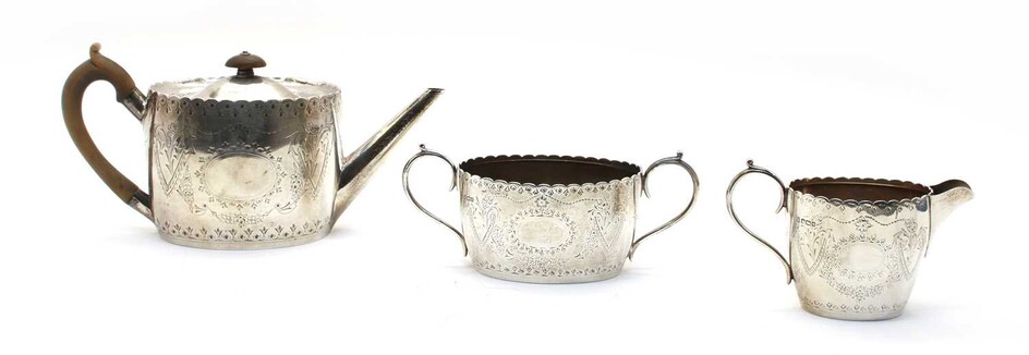 A composed silver three piece tea service