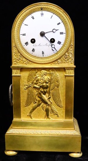 A gilt bronze and chiselled clock with a bas-relief of Cronos on an amati background framed by two pilasters with pediments.