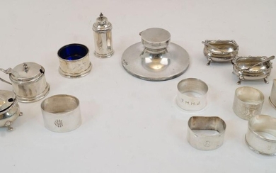 A group of silver, to include: a silver capstan inkwell, Chester, 1935, Reid & Sons Ltd., engraved REID & SONS LTD NEWCASTLE ON TYNE to edge, with opaque glass liner, 11.4cm dia.; a group of cruets to include a pair of open salts and spoons...