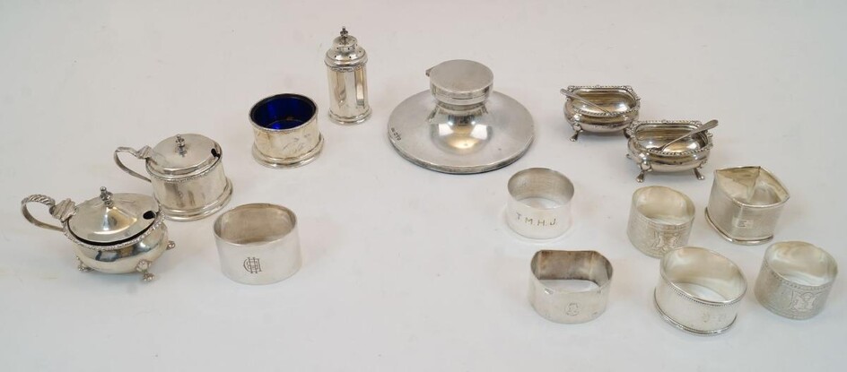 A group of silver, to include: a silver capstan inkwell, Chester, 1935, Reid & Sons Ltd., engraved REID & SONS LTD NEWCASTLE ON TYNE to edge, with opaque glass liner, 11.4cm dia.; a group of cruets to include a pair of open salts and spoons...